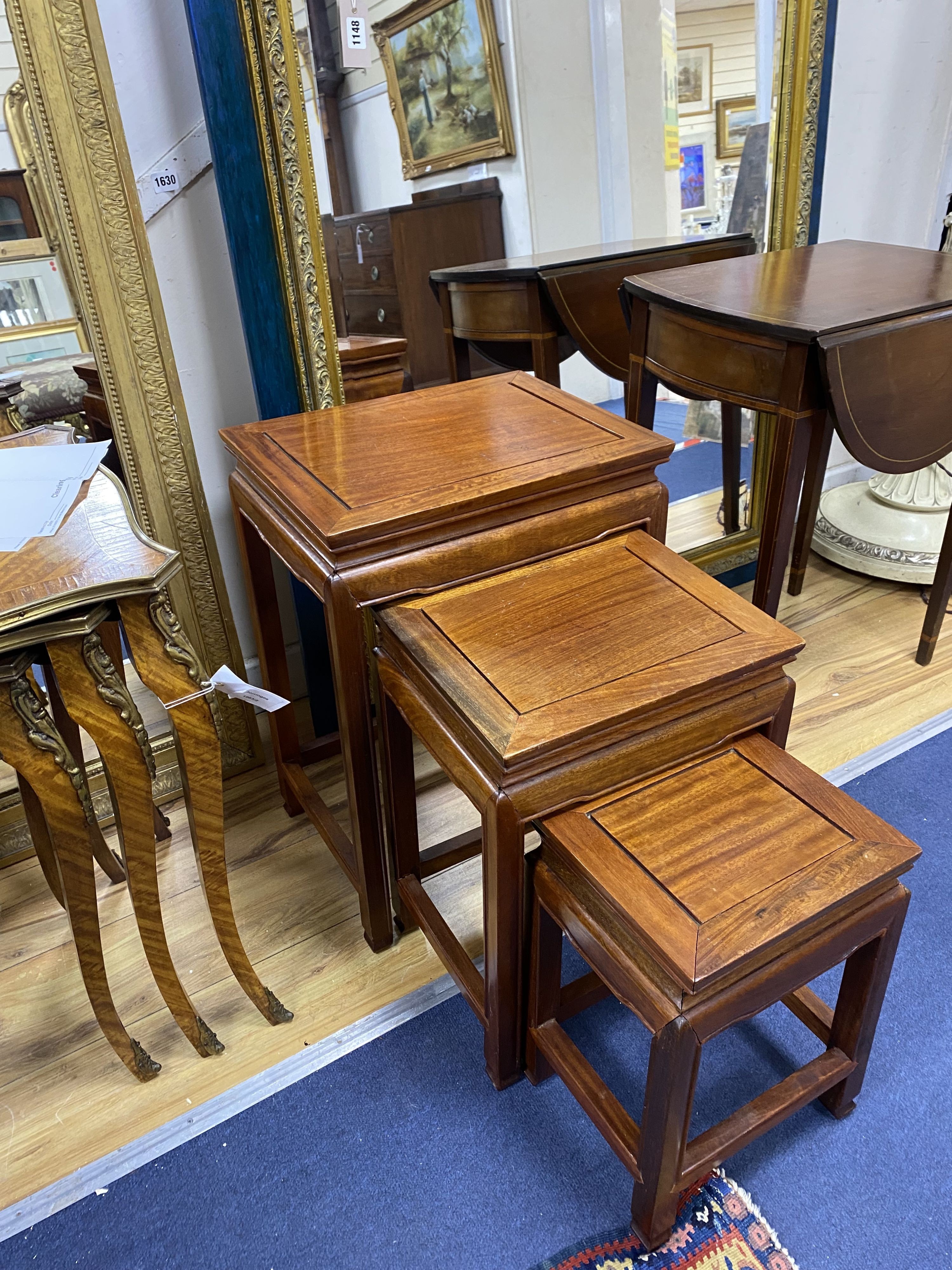 A nest of three rectangular Chinese occasional tables, width 40cm, depth 31cm, height 56cm
